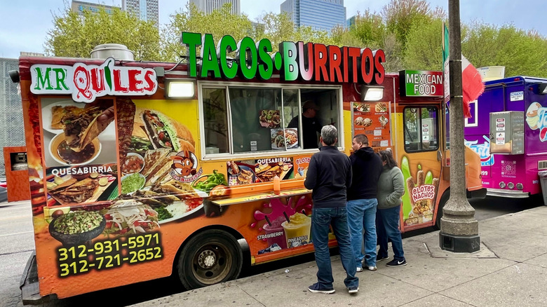 A taco truck with the Chicago skyline in the background