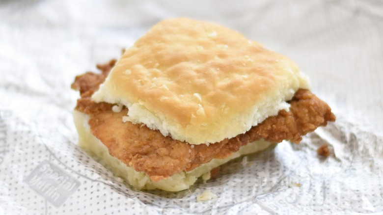 A Chick-fil-A chicken biscuit on a foil wrapper