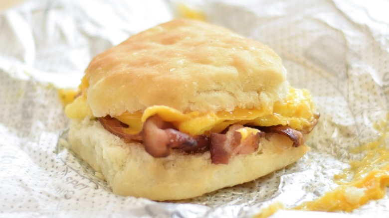 A Chick-fil-A bacon breakfast biscuit on a foil wrapper