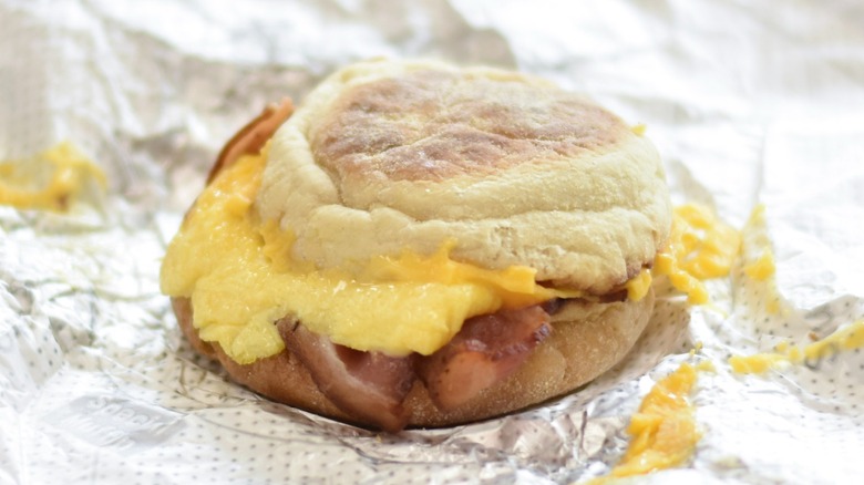 A Chick-fil-A bacon breakfast muffin on a foil wrapper