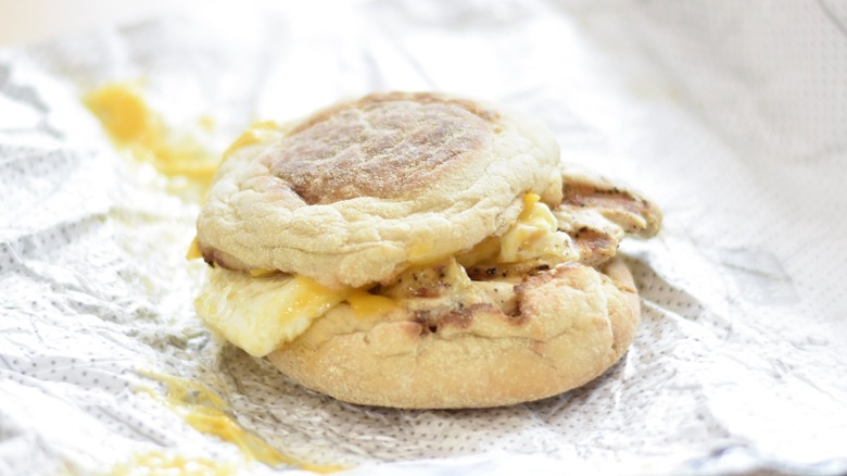 An egg white muffin sandwich on a foil wrapper