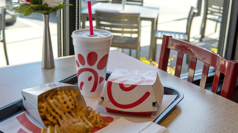 Chick-fil-A meal with a drink on a table beside a window