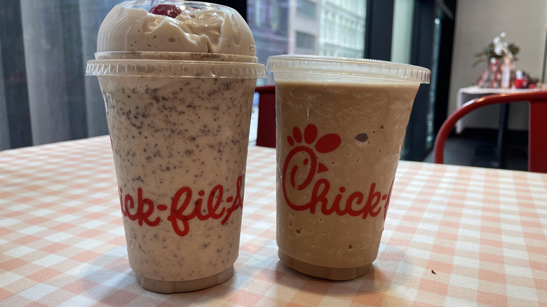 Two blended drinks from Chick-fil-A sit on a checkered tablecloth.
