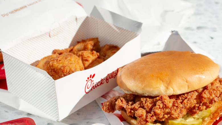 Box of Chick-fil-A chicken nuggets next to a chicken sandwich