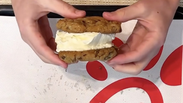 An employee holds the "secret" menu ice cream sandwich created at Chick-fil-A