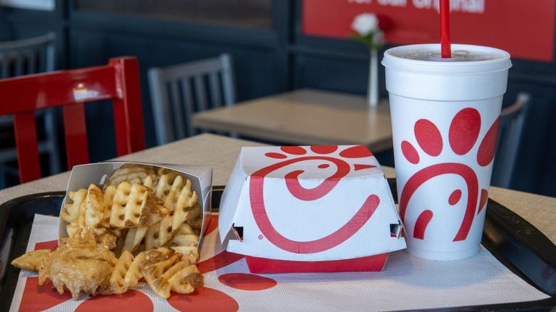 A chicken combo from Chick-fil-A with fries and a drink sitting on a tray inside the restaurant.