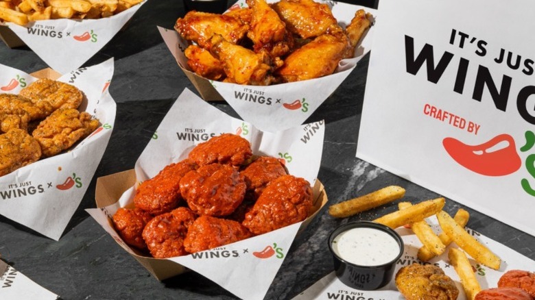 Variety of chicken wing options in small cardboard containers.