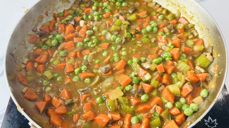 mixed vegetables and liquid in a frying pan