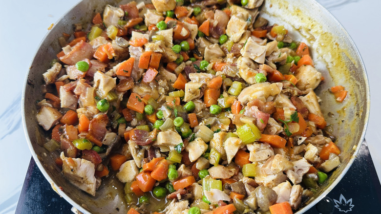 mixed vegetables and chopped chicken in a frying pan