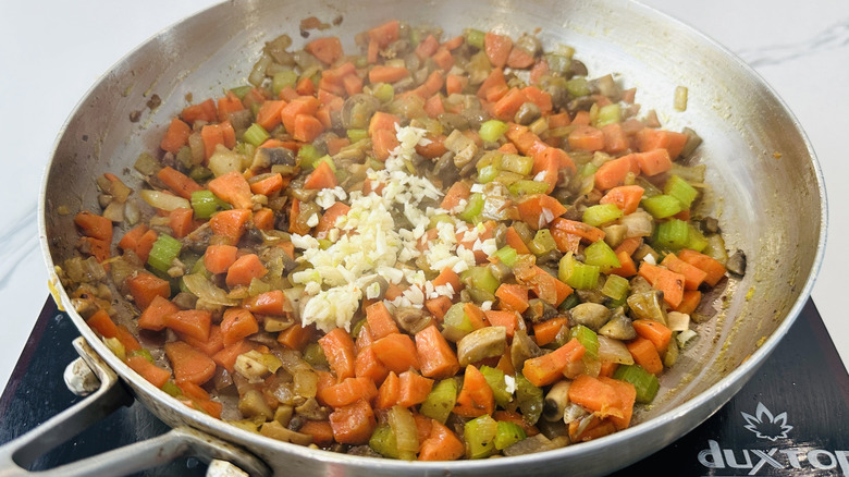 mixed vegetables and chopped garlic in a frying pan