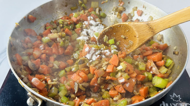 mixed vegetables and flour in a frying pan