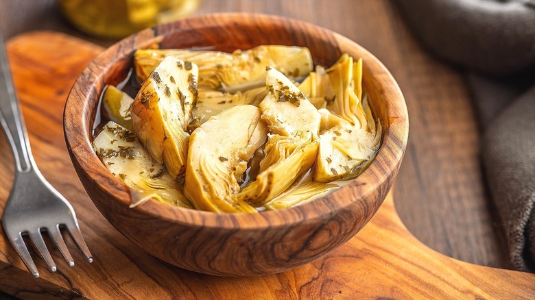 Marinated artichoke hearts in a bowl.