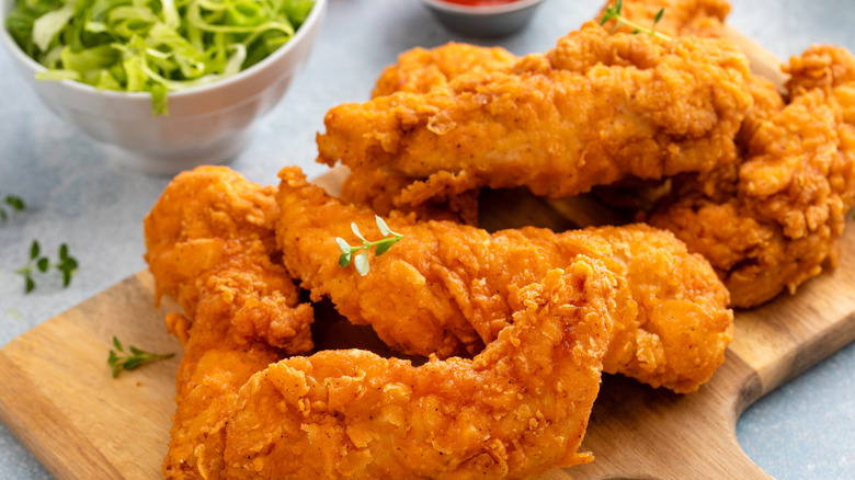 Chicken tenders on a wooden board