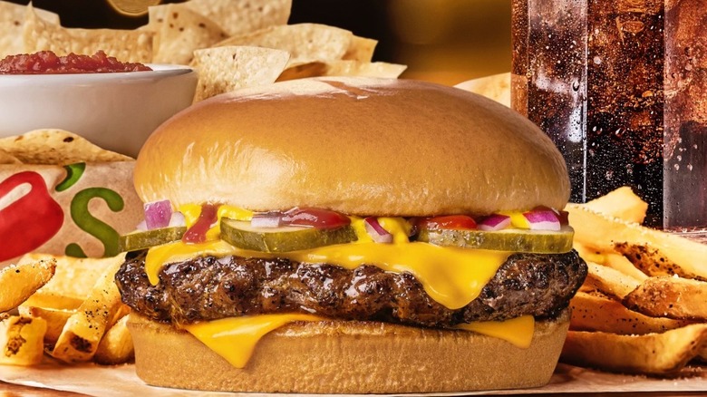 Close-up view of Chili's 3 For Meal special with chips and salsa, a cola, and a cheeseburger