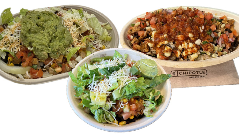 Three chicken burrito bowls on a white background