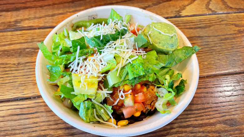 The chicken burrito bowl from Qdoba on wooden table