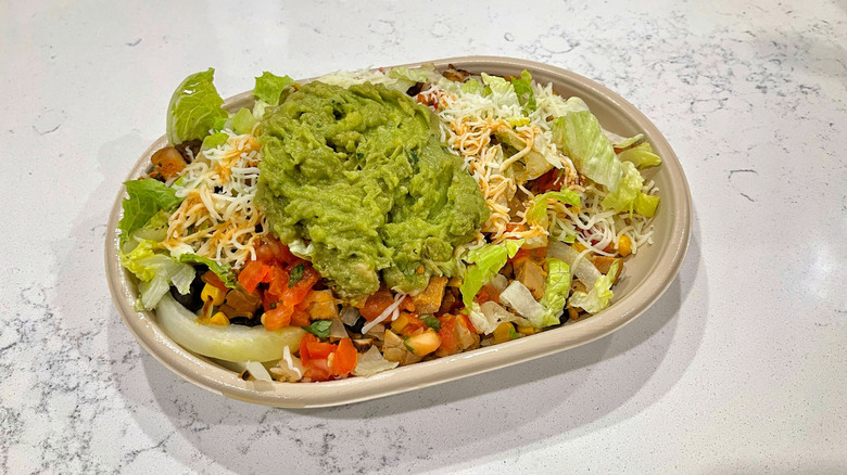 The chicken burrito bowl from Moe's on marble counter