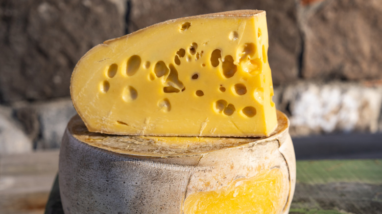a large piece of Gruyère cheese, sliced open