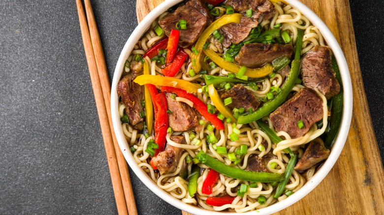 top down view of prepared lo mein with chopsticks on the side