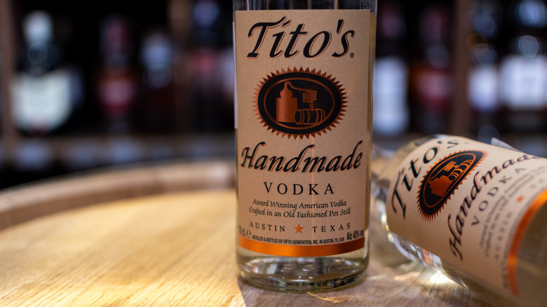 Bottle of Tito's Vodka on wooden barrel