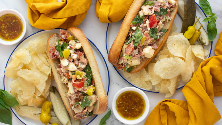 Overhead shot of two hoagie rolls stuffed with chopped Italian sandwich ingredients