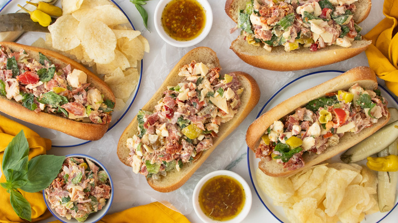 Overhead image of several hoagie rolls stuffed with chopped Italian sandwich ingredients