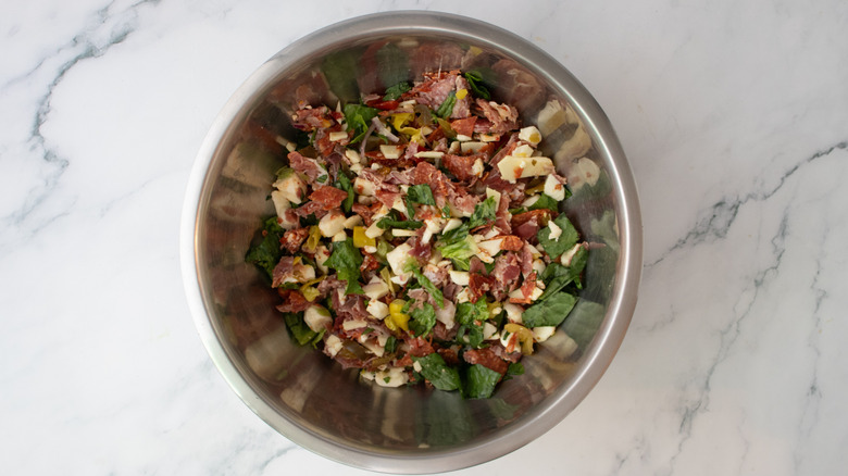 Chopped Italian sandwich ingredients in a large bowl