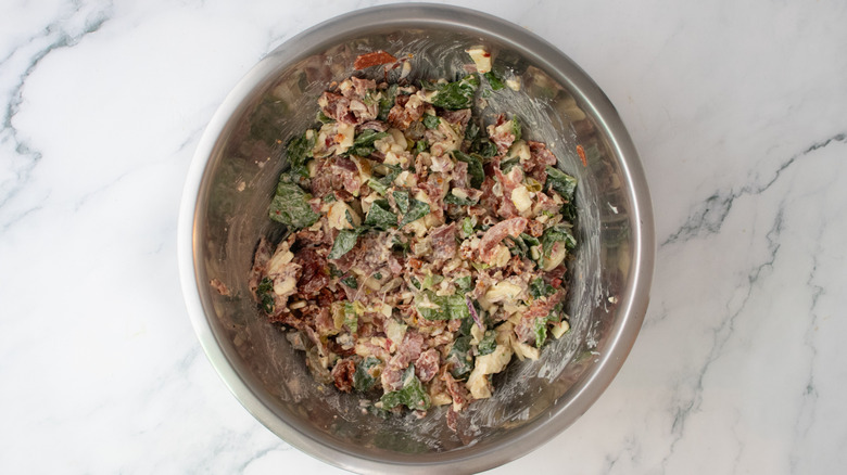 A creamy combination of chopped Italian sandwich ingredients in a large bowl