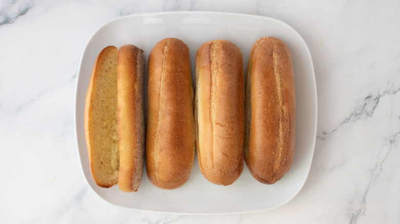 Toasted rolls on a white platter