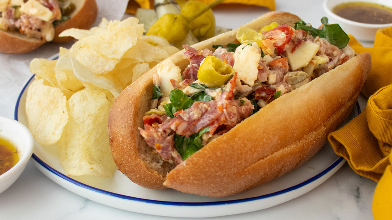 Side shot of a hoagie roll stuffed with chopped Italian sandwich ingredients