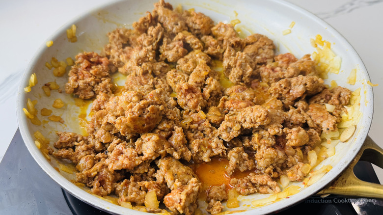 Chorizo and onion cooking in skillet