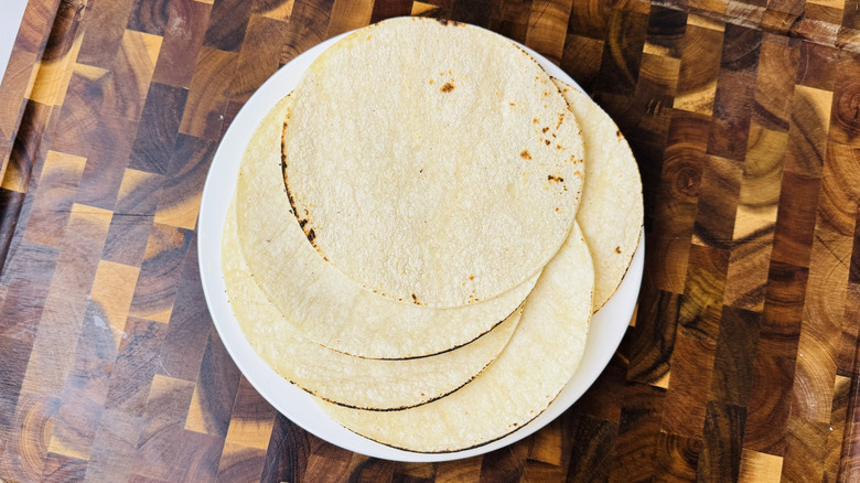 Warmed corn tortillas on plate