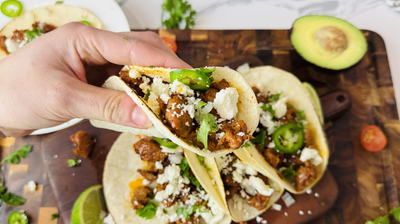 Holding chorizo street taco