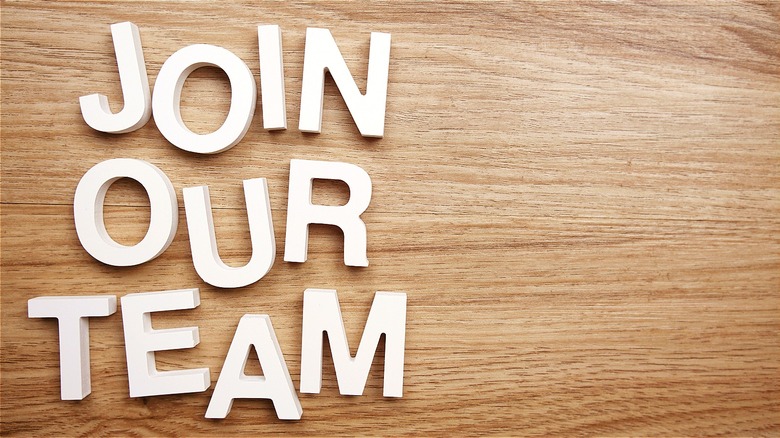 Join our team letters on wooden background