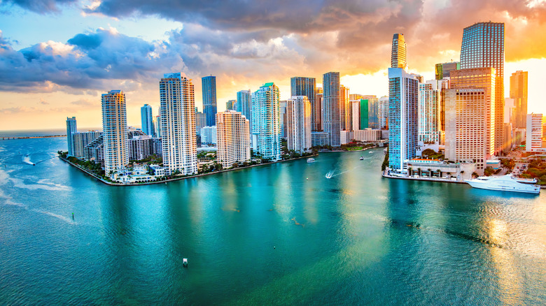 The sun sets behind the Miami skyline
