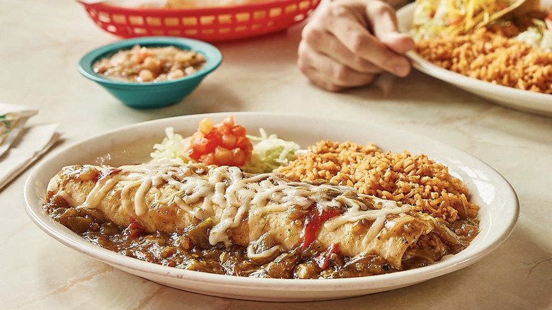 Several entrees served on a table at Chuy's Tex-Mex restaurant