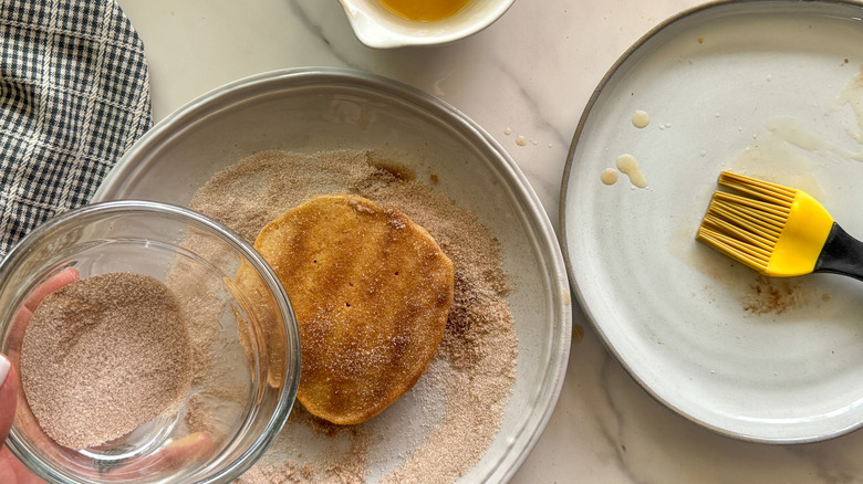 adding cinnamon sugar mixture to pancake