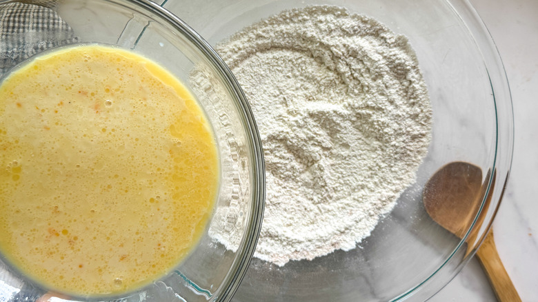 Egg mixture going into flour mixture in bowl