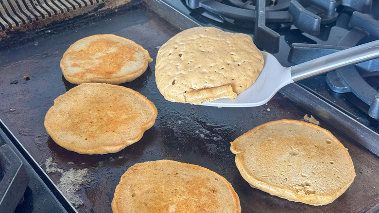 spatula flipping pancake on griddle