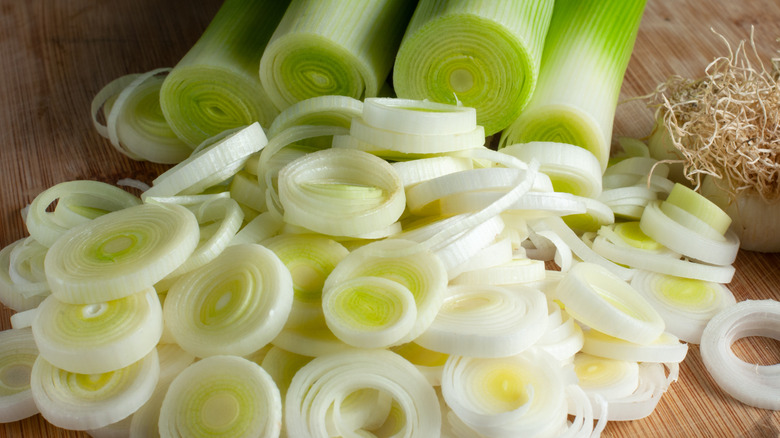 raw sliced leeks on a cutting board