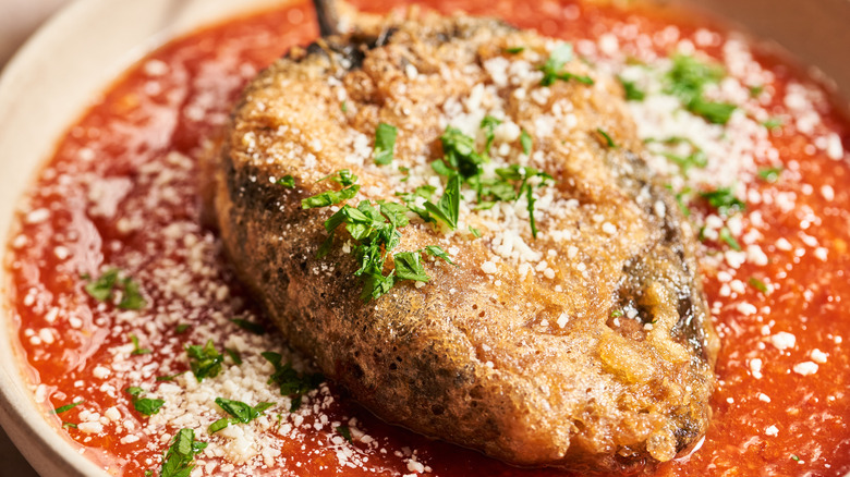 chiles rellenos on a plate with salsa