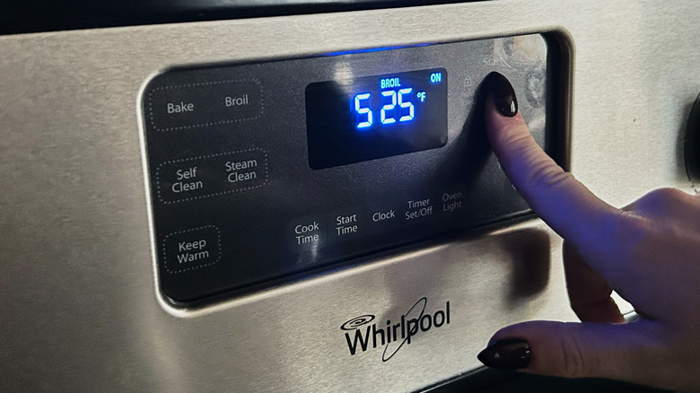 hand heating up the broiler