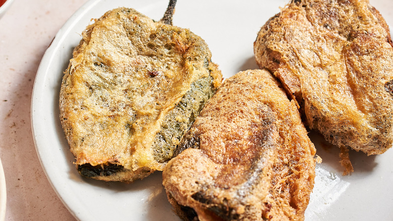 fried chiles rellenos on a plate