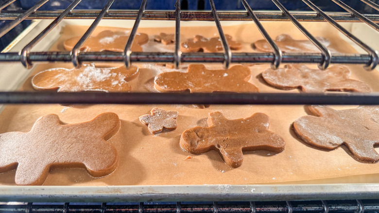 Gingerbread man cookies on sheet in oven