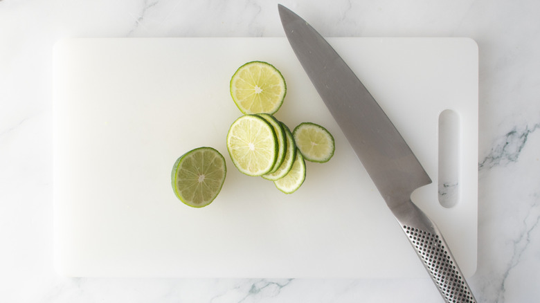 Lime slices on cutting board