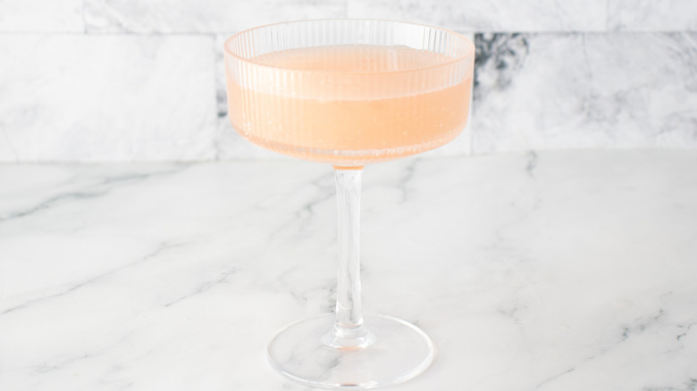 Cocktail strained into coupe glass