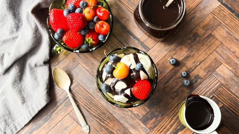 Classic hot fudge sauce in glass jar with spoon
