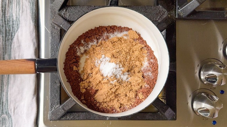 Cocoa powder, brown and white sugar, and salt in saucepan on stovetop