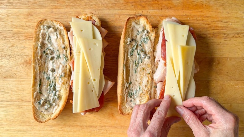 Adding slices of fontina and provolone to classic Italian-ish club sub sandwich