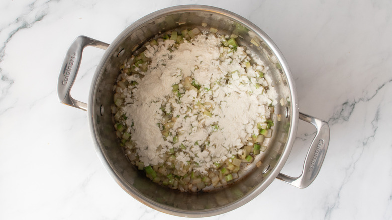 chopped vegetables and flour in a metal pot